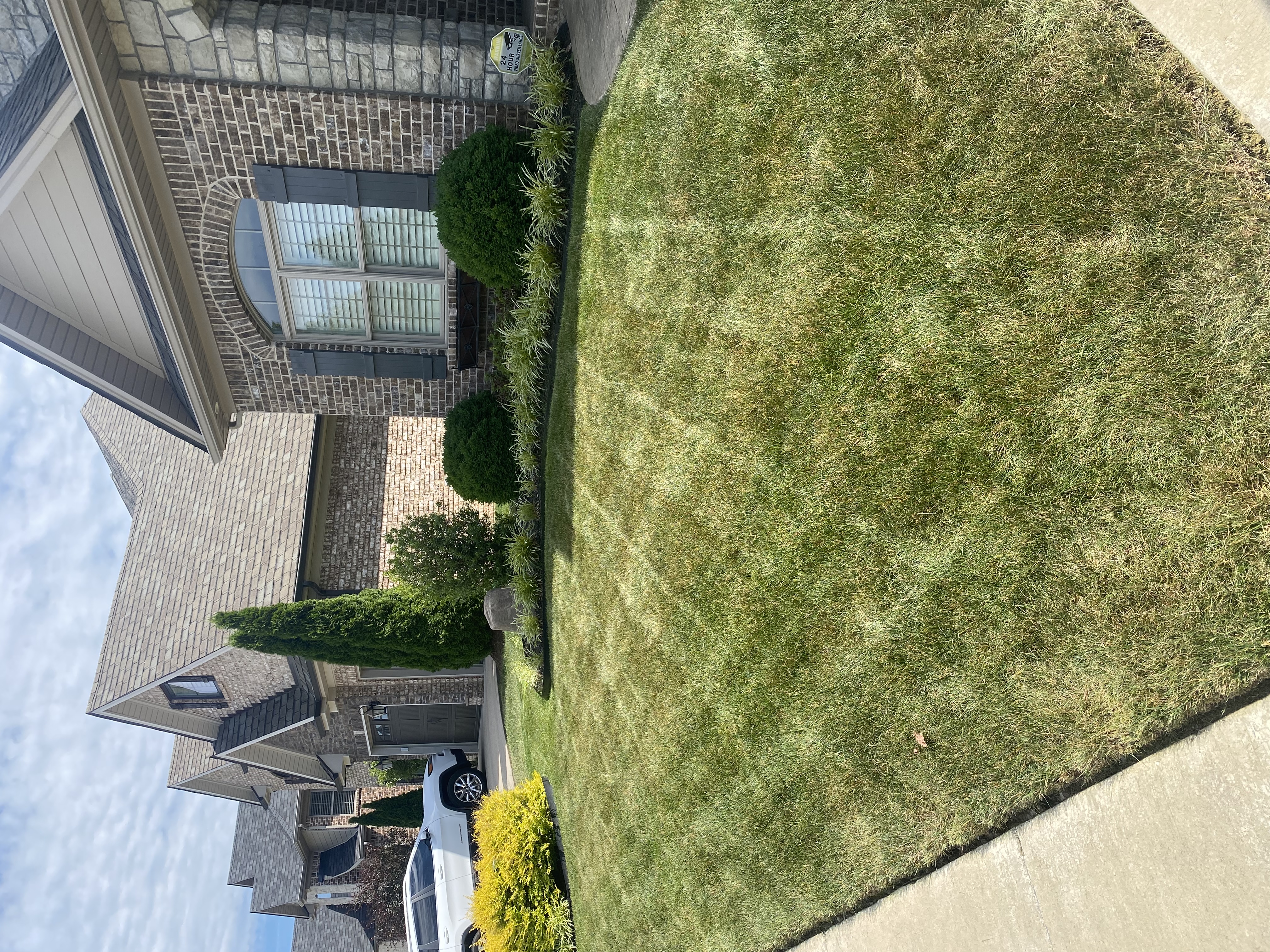 Front yard lawn with clean mow stripes and manicured landscape beds